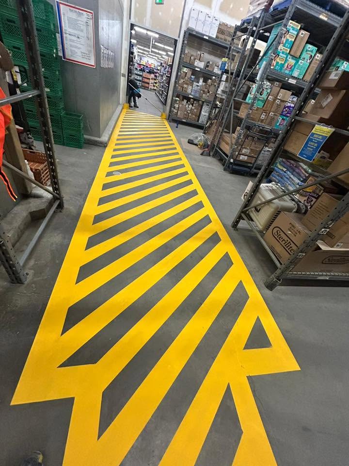 Warehouse floor with crisp new yellow safety striping