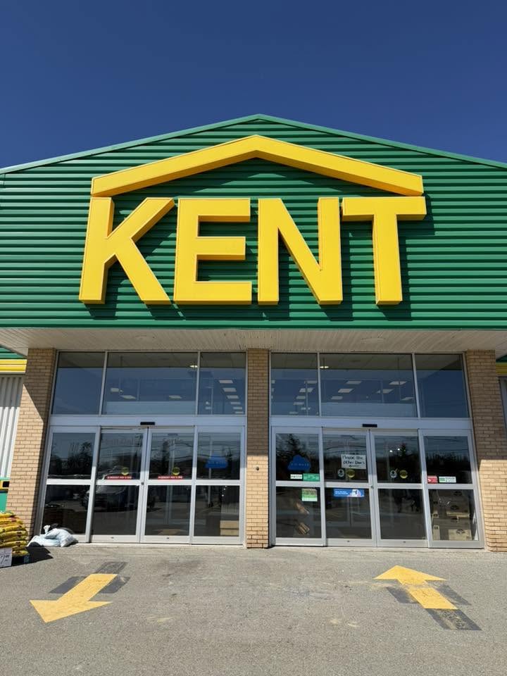 Freshly painted commercial store exterior with green siding and bright signage