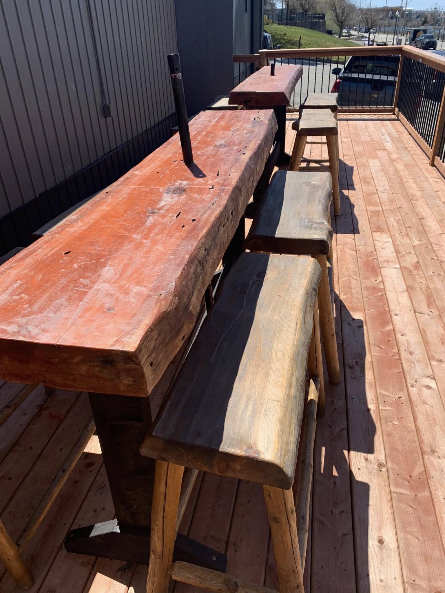 Weathered, faded patio benches and bar table before restoration