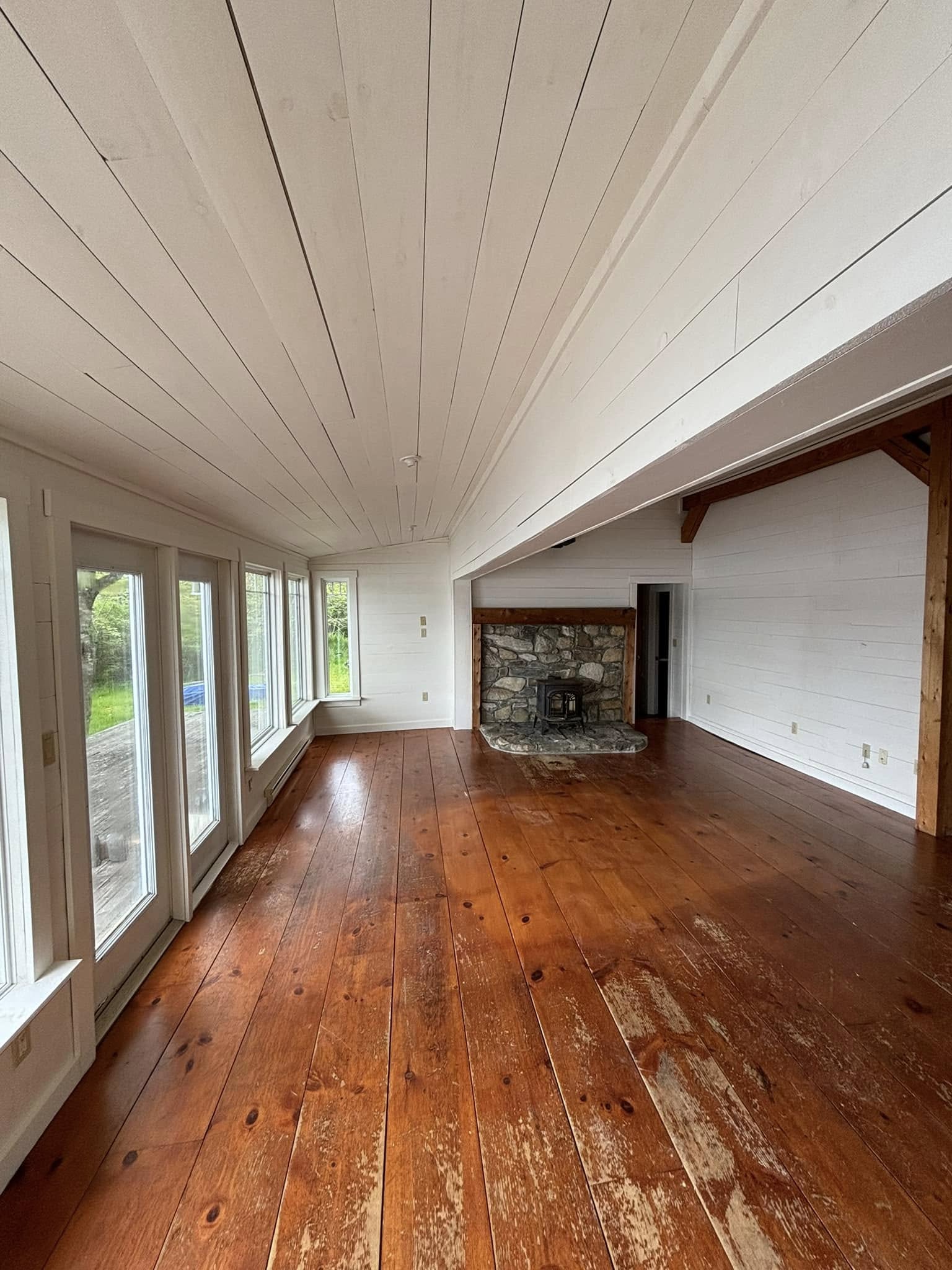 Sunroom brightened with white painted walls and ceiling