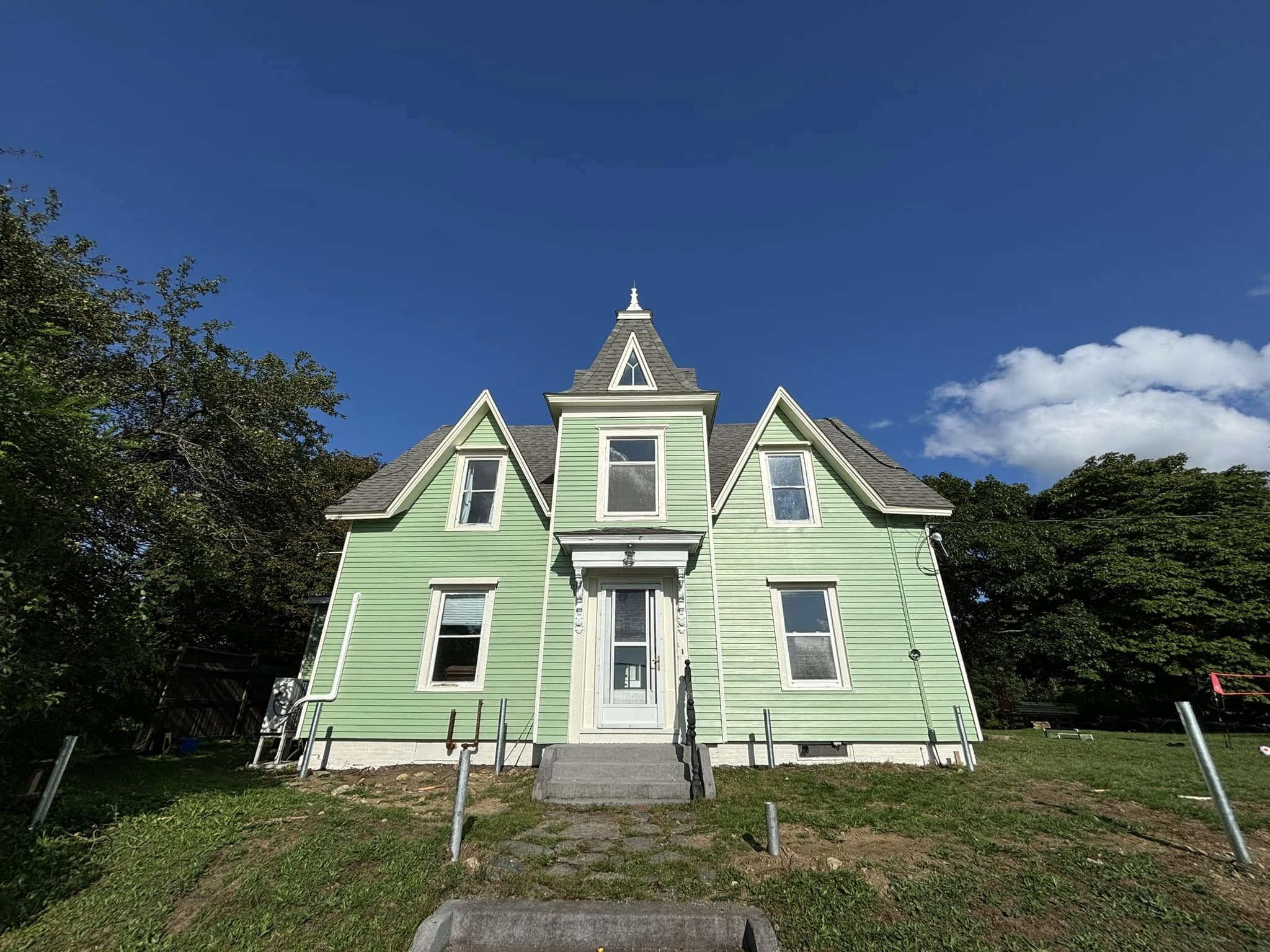 Heritage home repainted in sage green with cream trim