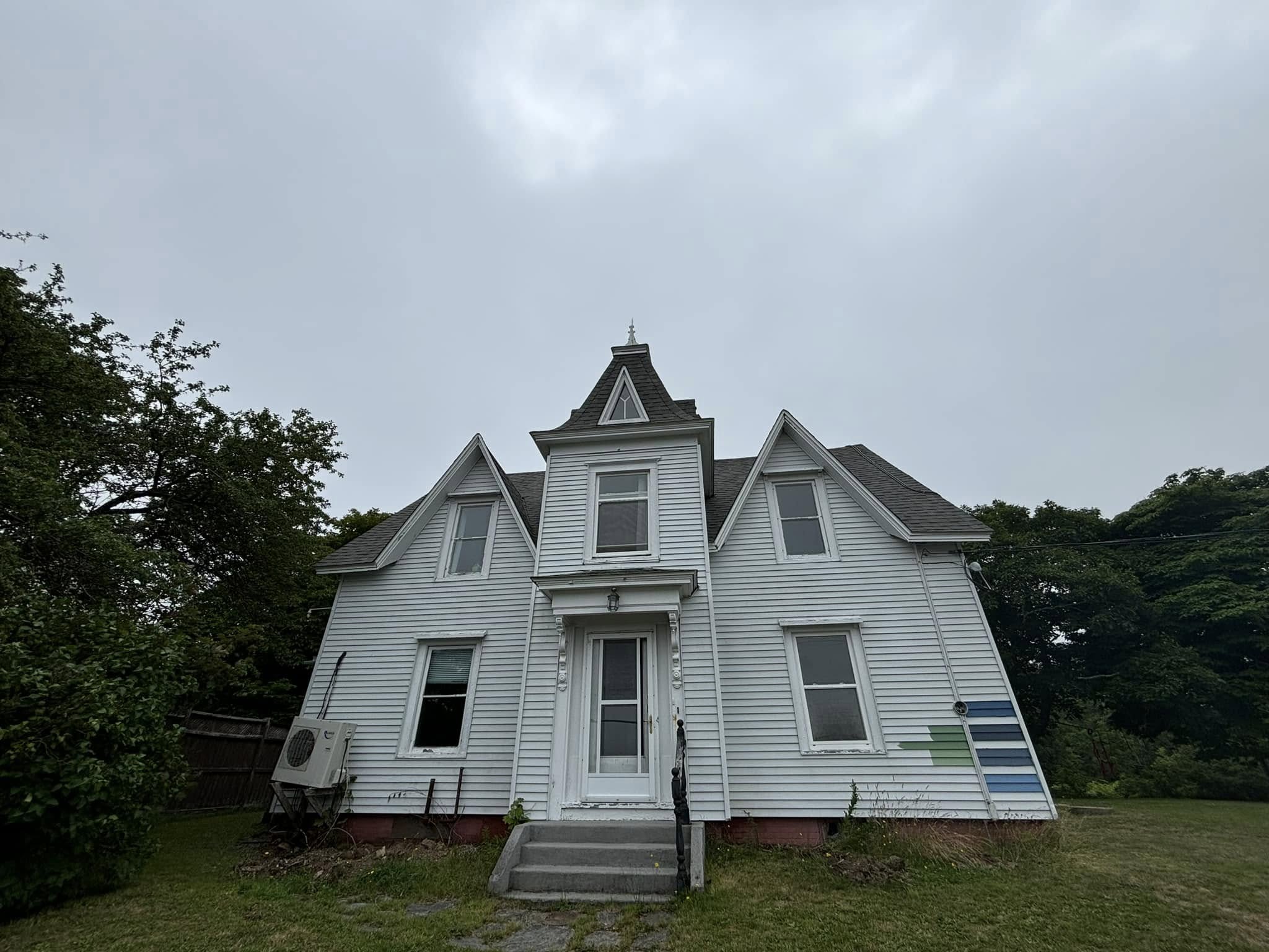 Heritage farmhouse with faded exterior before repainting