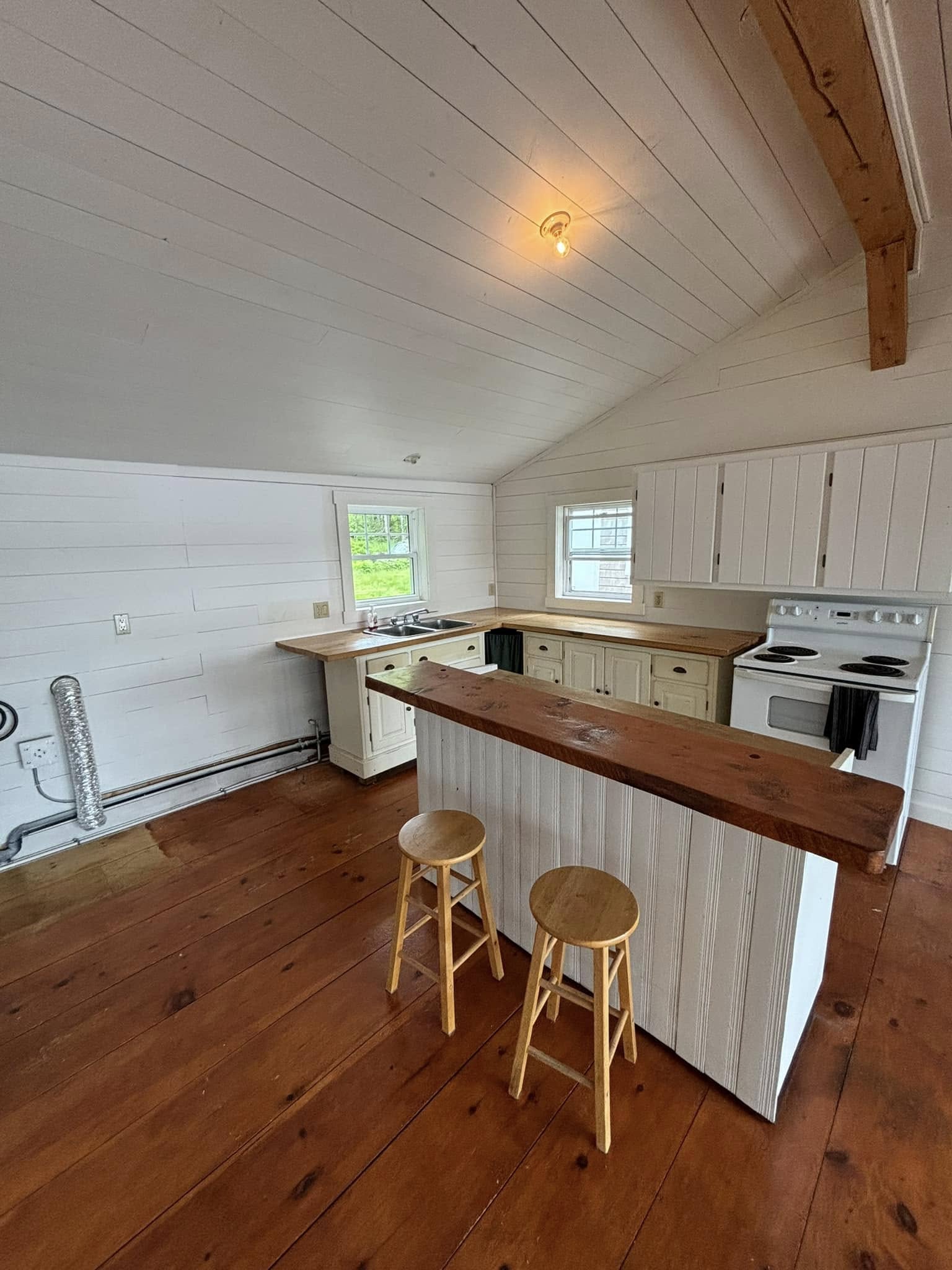 Cottage interior brightened with white painted walls and ceiling